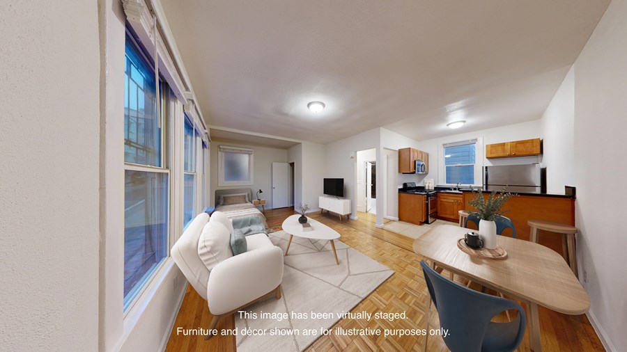 A living room with a white couch and a wooden table.
